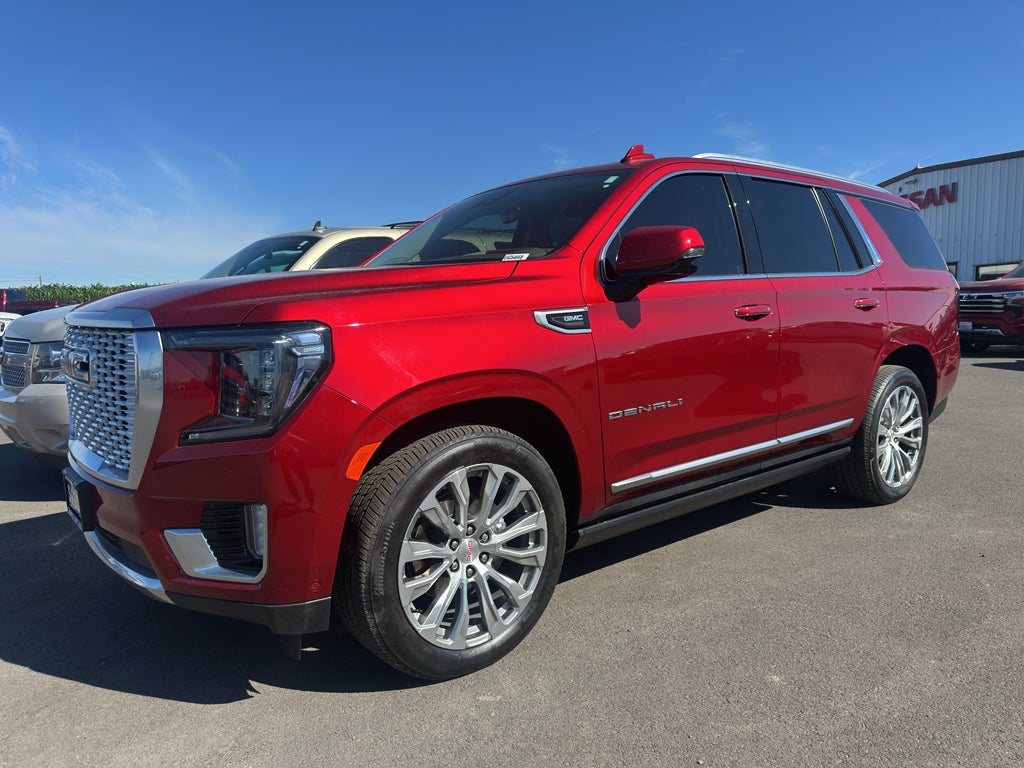 2023 GMC Yukon 4WD Denali in Volcanic Red Tintcoat — front three-quarter view